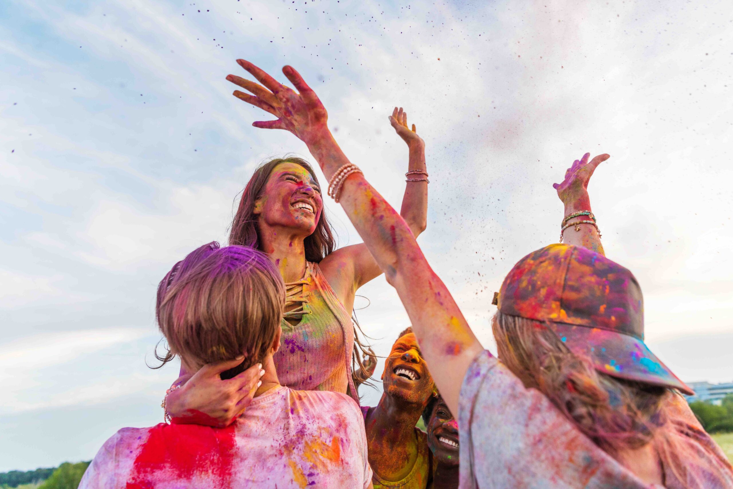 Happy Young Friends With Outstretched Hands Having Fun Together At Holi Festival