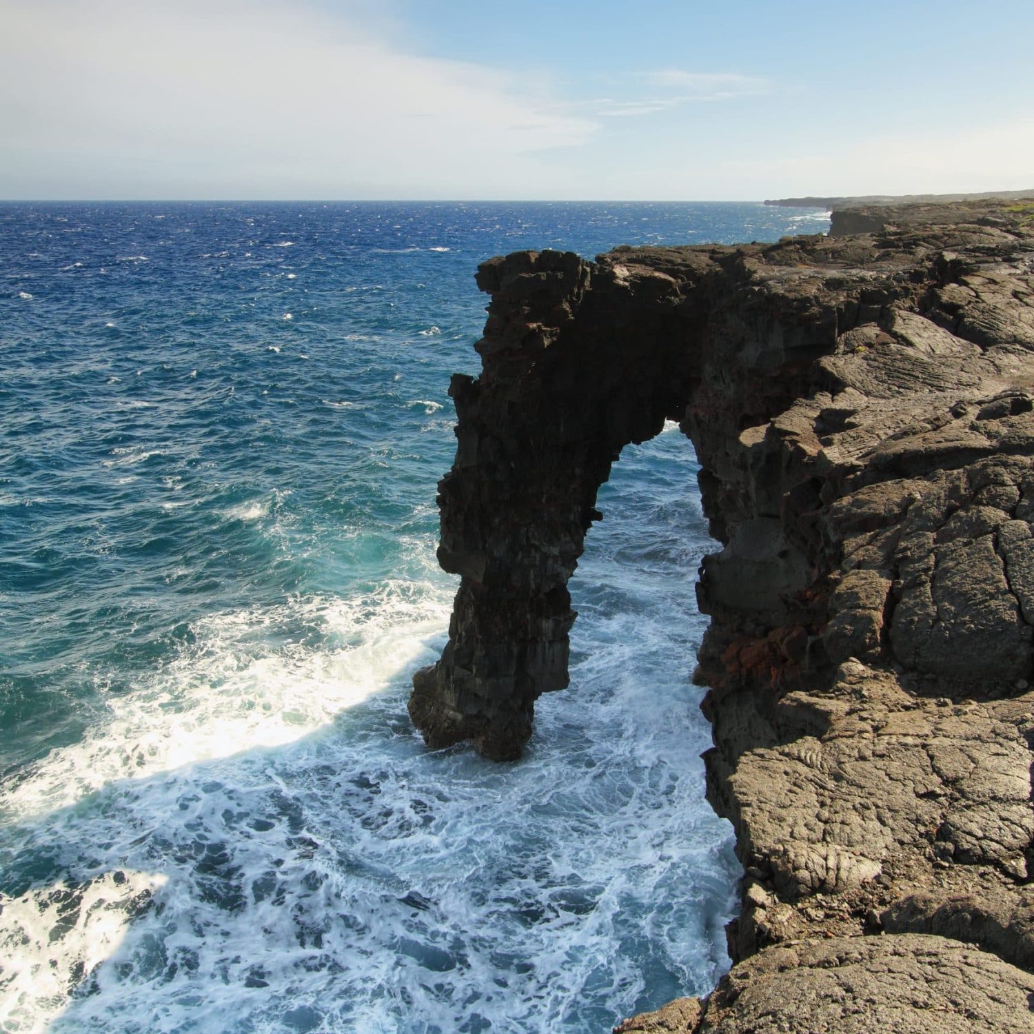 Natural Arch In The Black Lava Rock Cliffs