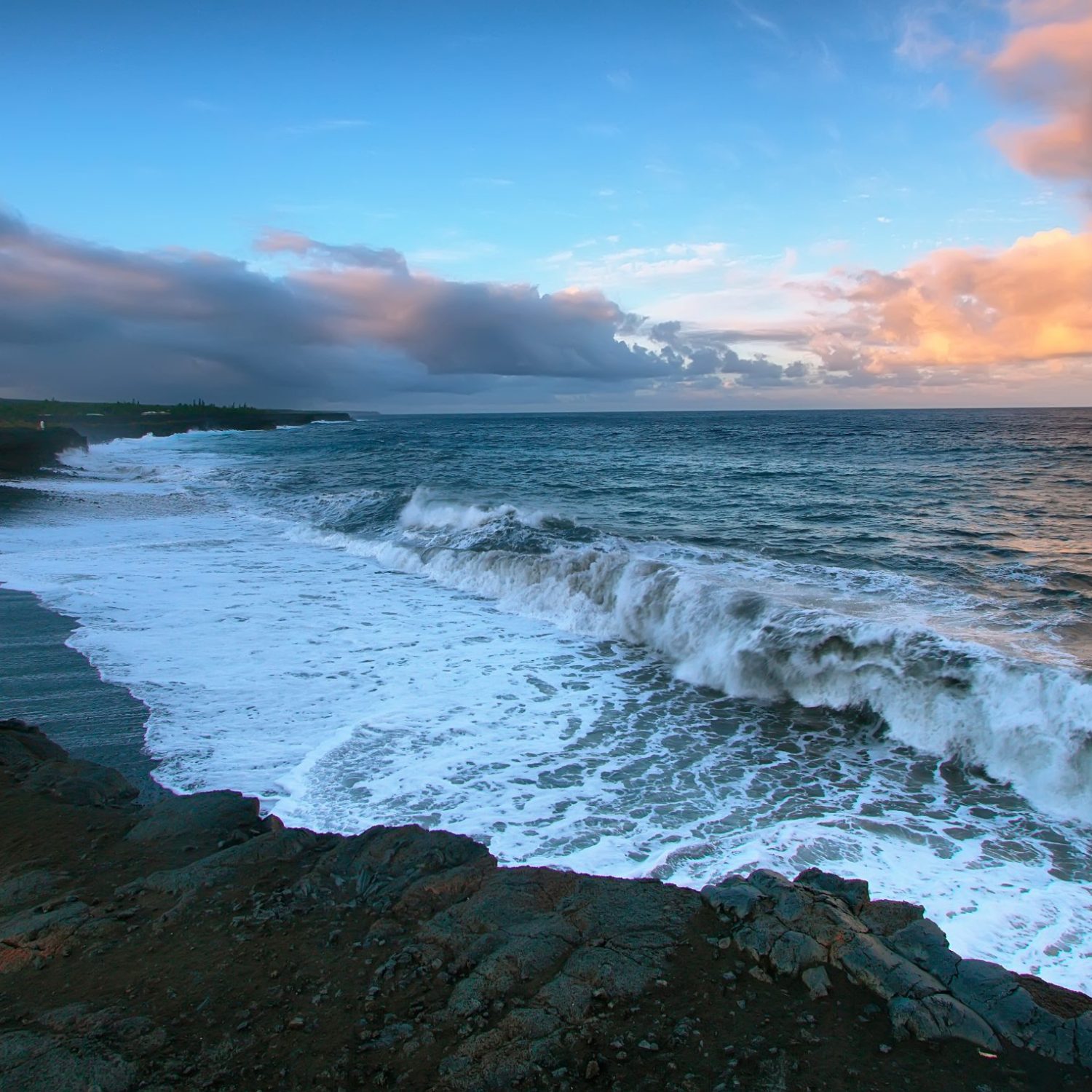 Views Of The Sea And Black Lava Rocks At Sunset